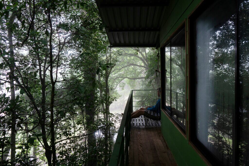 A serene eco-wellness resort in the Costa Rican rainforest, featuring an open-air yoga deck and natural surroundings.