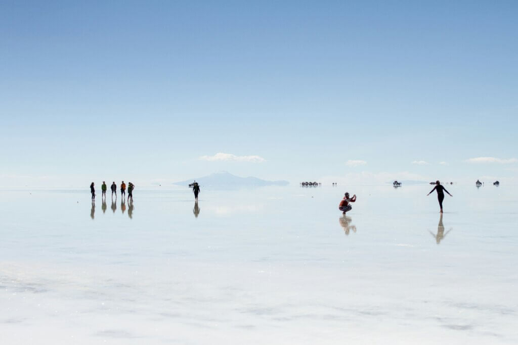 Vast salt flat in Bolivia reflecting the sky like a giant mirror after rainfall.