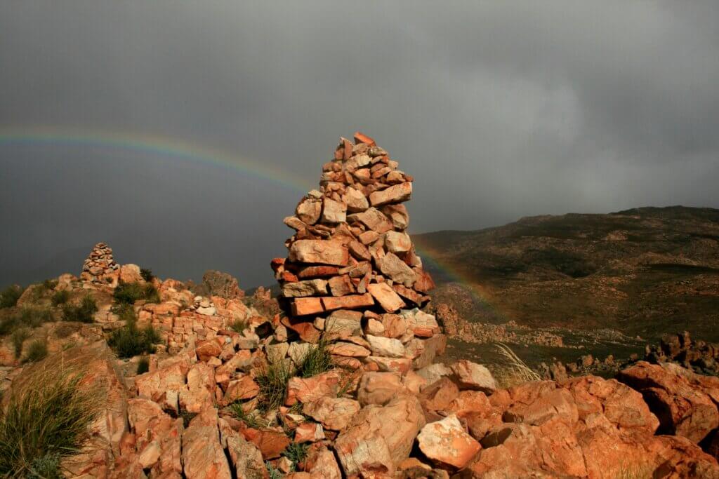 Dramatic red rock formations in Cederberg Wilderness, South Africa, with a starry night sky overhead.