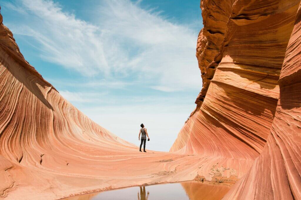 Wavy sandstone rock formation in Arizona with vibrant orange and red colors.