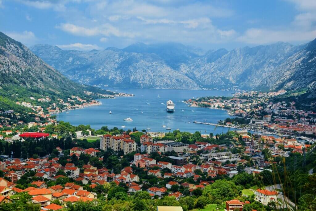 A stunning view of the Bay of Kotor, Montenegro, with its deep blue waters surrounded by towering mountains.