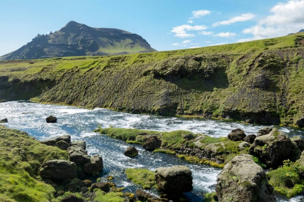 Scenic view of the Laugavegur Trail in Iceland, featuring colorful rhyolite mountains and a winding hiking path.