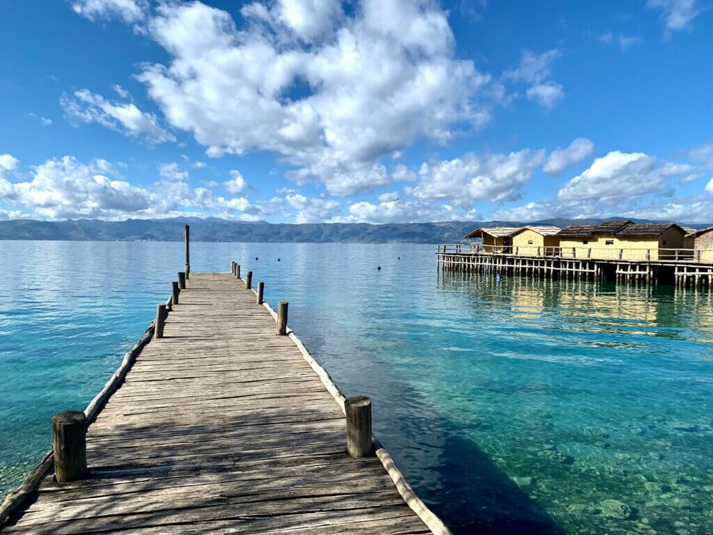 The serene Ohrid Lake, North Macedonia, with crystal-clear waters and picturesque mountain surroundings.