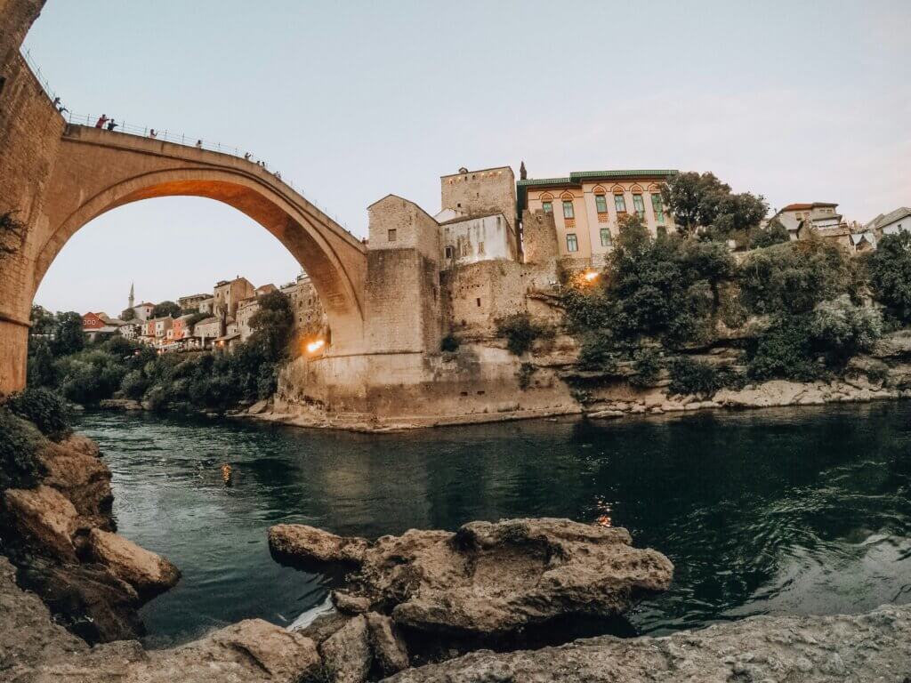 The historic Stari Most (Old Bridge) in Mostar, Bosnia and Herzegovina, arching gracefully over the emerald-green Neretva River.