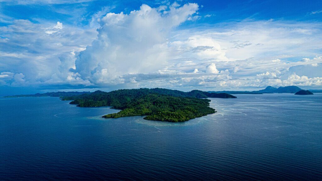Aerial view of a small lush island in the Togean archipelago, Indonesia